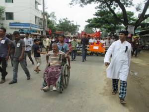 Bablu Roy who was shot to the spinal cord on 26 August 2006 by the armed force of the state is leading the rally of Central National Committee on his wheel chair. He looks forty something in his thirties. 