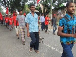 Another busy man of Phulbari is participating in the rally, but this time it seems that he will be late with his business with the chicken. Perhaps he is returning to his home to cook it, I wonder.